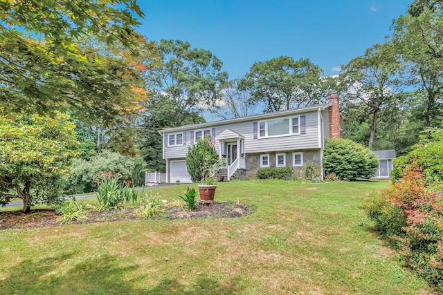 59 Laurel Wood Dr, Shelton, CT 06484 - split foyer home with a chimney, an attached garage, and a front yard