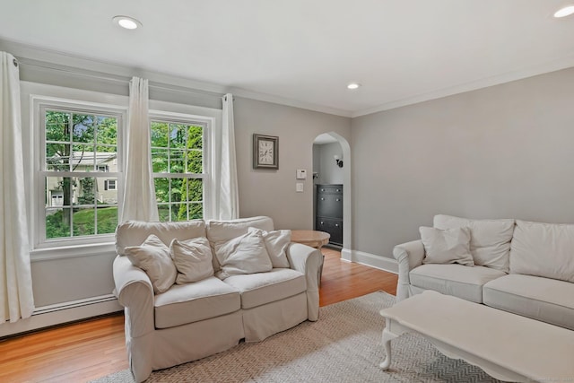 8 Gillies Ln, Norwalk, CT 06854 - living room with arched walkways, light wood-type flooring, recessed lighting, a baseboard heating unit, and ornamental molding