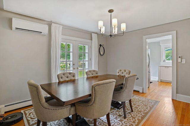 8 Gillies Ln, Norwalk, CT 06854 - dining space featuring an AC wall unit, a chandelier, a baseboard heating unit, light wood finished floors, and french doors