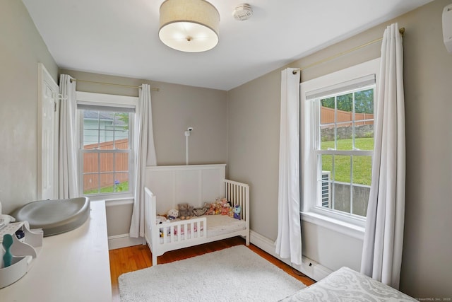8 Gillies Ln, Norwalk, CT 06854 - bedroom featuring wood finished floors and a wall unit AC