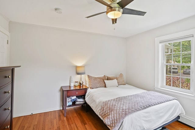 8 Gillies Ln, Norwalk, CT 06854 - bedroom featuring a baseboard radiator, wood finished floors, and ceiling fan