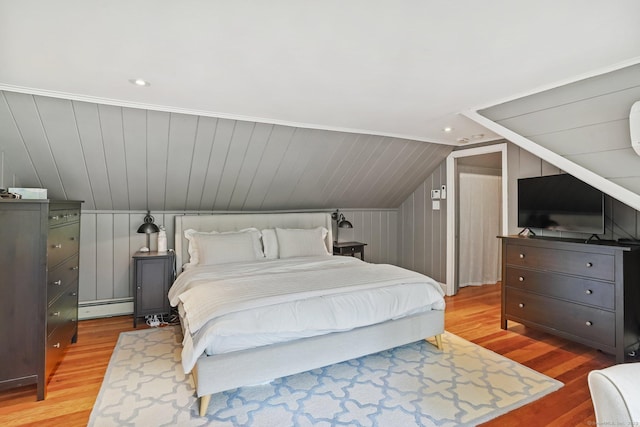 8 Gillies Ln, Norwalk, CT 06854 - bedroom with baseboard heating, vaulted ceiling, light wood-style floors, and recessed lighting