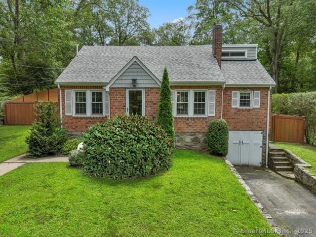 8 Gillies Ln, Norwalk, CT 06854 - bungalow featuring brick siding, a chimney, and roof with shingles