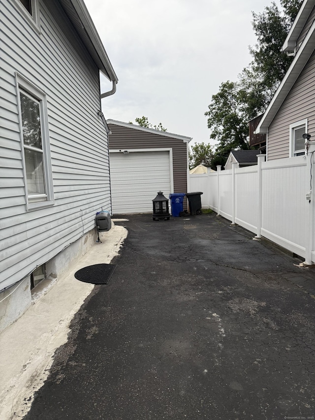 32 S St, Norwalk, CT 06854 - view of property exterior featuring asphalt driveway and an outbuilding