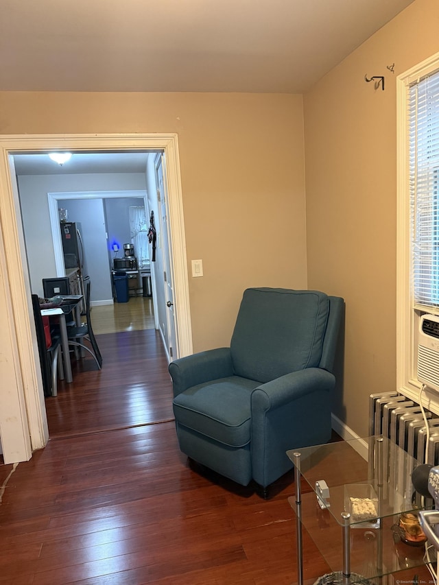 32 S St, Norwalk, CT 06854 - sitting room with radiator heating unit, dark wood-style flooring, and a desk