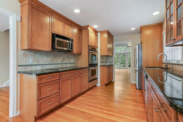 21 Lakeview Ave Unit 21, New Canaan, CT 06840 - kitchen featuring stainless steel appliances, light wood-type flooring, glass insert cabinets, dark stone counters, and recessed lighting