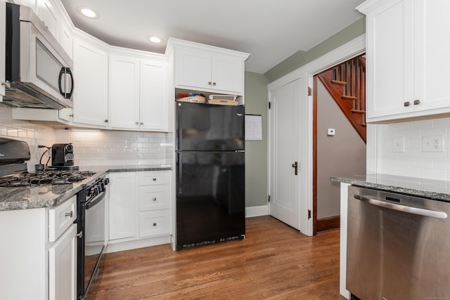 27 Thornton St, Hamden, CT 06517 - kitchen featuring black appliances, light wood-style floors, stone counters, white cabinetry, and backsplash