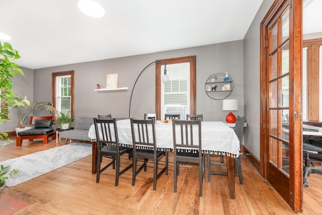 27 Thornton St, Hamden, CT 06517 - dining space with light wood finished floors and a fireplace