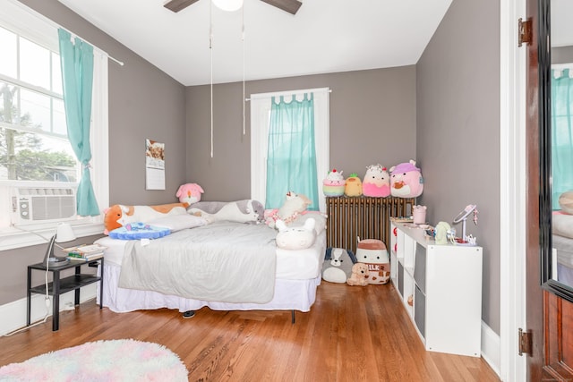 27 Thornton St, Hamden, CT 06517 - bedroom featuring radiator, multiple windows, wood finished floors, and cooling unit