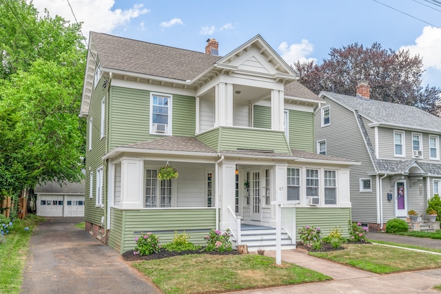 27 Thornton St, Hamden, CT 06517 - view of front of house featuring an outdoor structure, a detached garage, a chimney, a shingled roof, and a porch