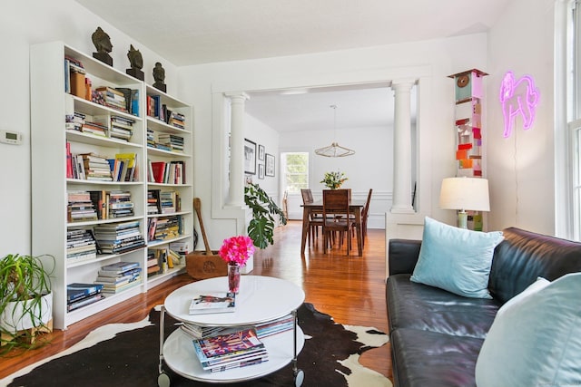 24 Warren Ave, Groton, CT 06355 - living area with decorative columns, wood finished floors, and a chandelier