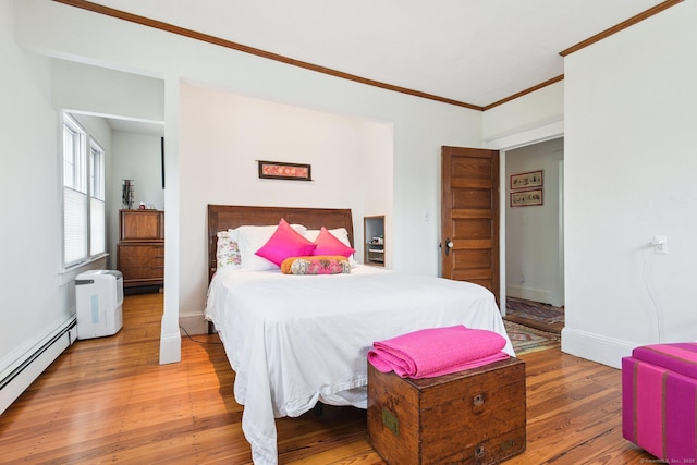 24 Warren Ave, Groton, CT 06355 - bedroom with baseboard heating, crown molding, and light wood-style floors