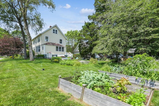 24 Warren Ave, Groton, CT 06355 - view of grassy yard with a vegetable garden