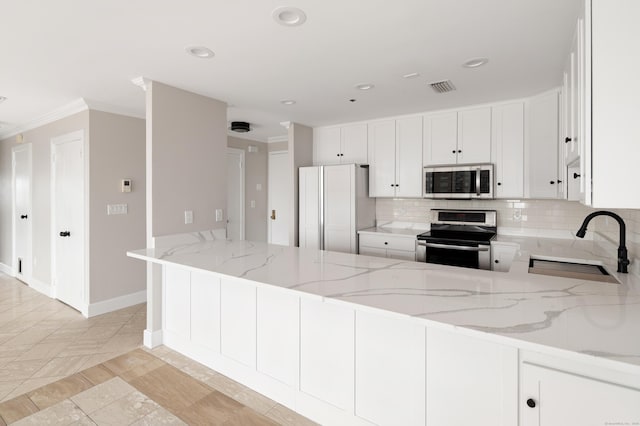 104 N St Apt 803, Stamford, CT 06902 - kitchen with appliances with stainless steel finishes, backsplash, light stone countertops, a peninsula, and white cabinetry