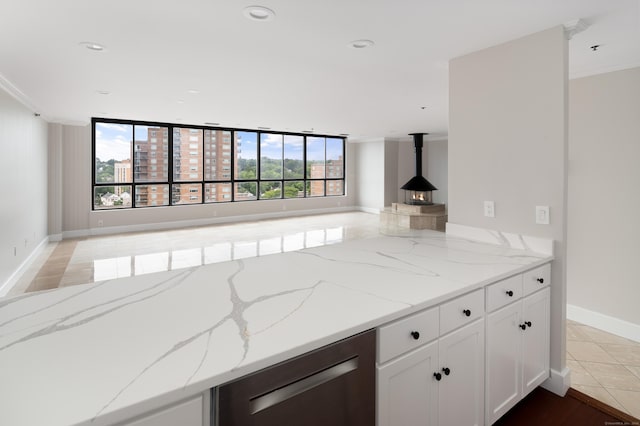104 N St Apt 803, Stamford, CT 06902 - kitchen with light stone countertops, dishwasher, open floor plan, white cabinets, and ornamental molding