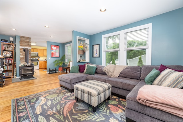 610 S Elm St, Wallingford, CT 06492 - living area featuring a wood stove, light wood-style floors, and recessed lighting