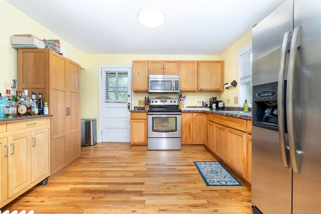 610 S Elm St, Wallingford, CT 06492 - kitchen featuring appliances with stainless steel finishes, dark countertops, and light wood-style flooring
