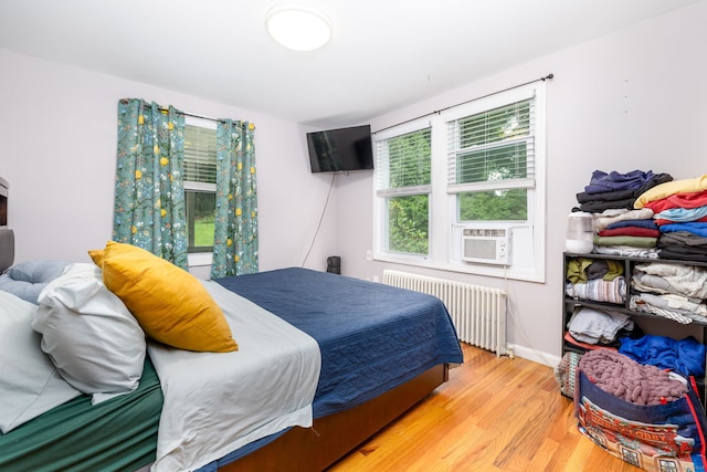 610 S Elm St, Wallingford, CT 06492 - bedroom featuring radiator, wood finished floors, and cooling unit