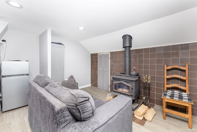 610 S Elm St, Wallingford, CT 06492 - living room featuring a wood stove, recessed lighting, light wood-style flooring, and vaulted ceiling