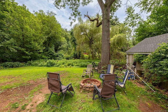 610 S Elm St, Wallingford, CT 06492 - view of grassy yard with a fire pit and a forest view