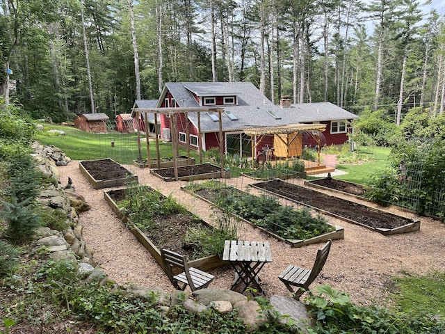 23 Little Bunggee Hill Rd, Woodstock, CT 06282 - rear view of house featuring a vegetable garden, a yard, and a wooded view