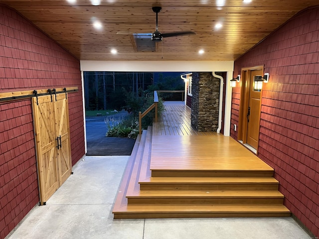 23 Little Bunggee Hill Rd, Woodstock, CT 06282 - stairs with lofted ceiling, a barn door, recessed lighting, wood walls, and concrete flooring