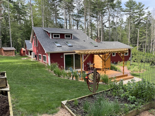 23 Little Bunggee Hill Rd, Woodstock, CT 06282 - rear view of house featuring a shingled roof, a vegetable garden, a lawn, and a deck
