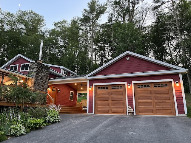 23 Little Bunggee Hill Rd, Woodstock, CT 06282 - view of front of home featuring driveway, an attached garage, and view of wooded area