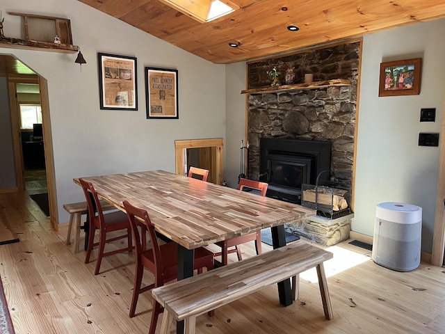 23 Little Bunggee Hill Rd, Woodstock, CT 06282 - dining space featuring light wood-style floors, lofted ceiling, wood ceiling, a stone fireplace, and a skylight