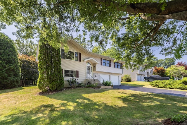 111 Nicole Dr, Milford, CT 06460 - split foyer home featuring driveway, an attached garage, and a front lawn