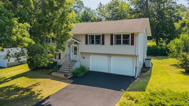 111 Nicole Dr, Milford, CT 06460 - raised ranch with asphalt driveway, a front yard, and a garage