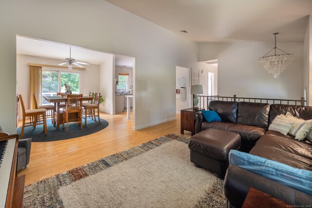 111 Nicole Dr, Milford, CT 06460 - living area with light wood-style flooring, a chandelier, a ceiling fan, and vaulted ceiling