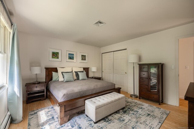 111 Nicole Dr, Milford, CT 06460 - bedroom featuring a baseboard radiator, light wood finished floors, and a closet