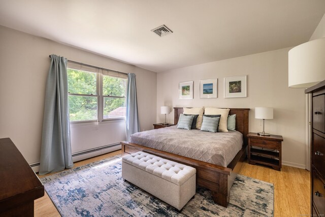 111 Nicole Dr, Milford, CT 06460 - bedroom featuring a baseboard heating unit and wood finished floors