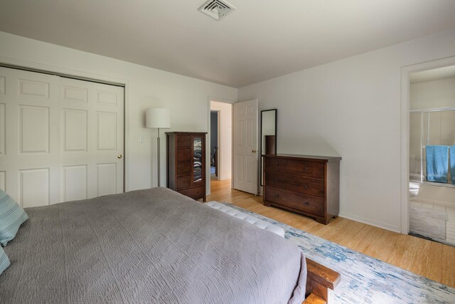 111 Nicole Dr, Milford, CT 06460 - bedroom with wood finished floors, a closet, and connected bathroom