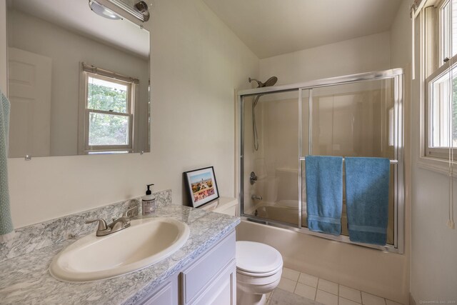 111 Nicole Dr, Milford, CT 06460 - full bath with vanity, plenty of natural light, tile patterned floors, and shower / bath combination with glass door
