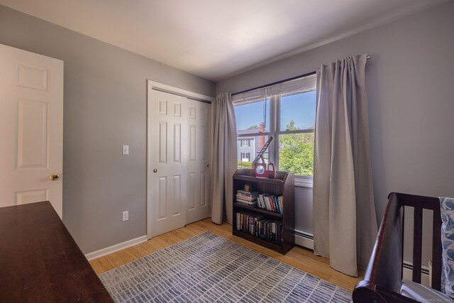 111 Nicole Dr, Milford, CT 06460 - bedroom with light wood-style flooring, a baseboard heating unit, and a closet