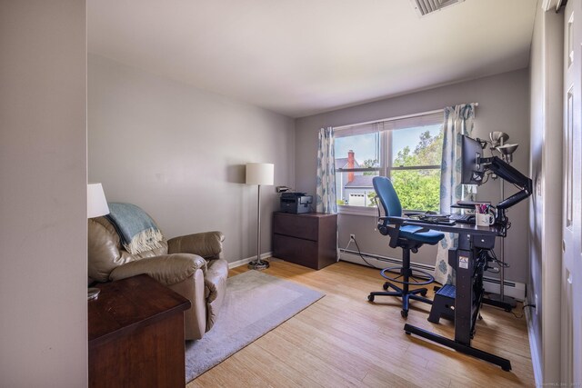 111 Nicole Dr, Milford, CT 06460 - home office with wood finished floors and a baseboard heating unit