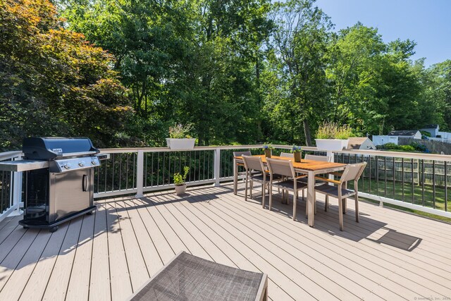 111 Nicole Dr, Milford, CT 06460 - wooden terrace featuring area for grilling, outdoor dining area, and view of wooded area