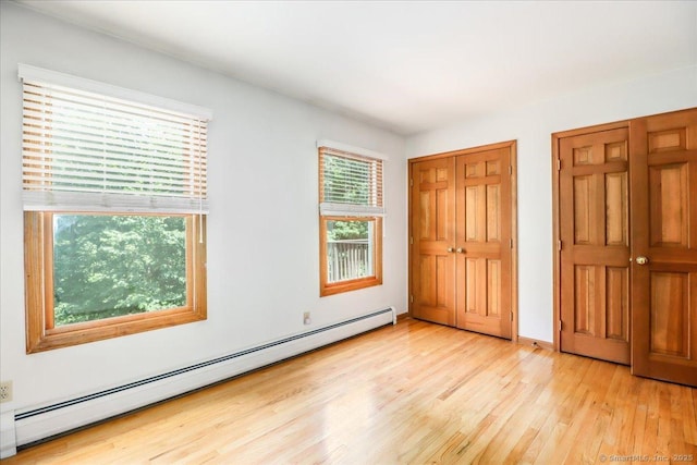 6 Big Buck Ln, Brookfield, CT 06804 - unfurnished bedroom featuring a baseboard heating unit and light wood finished floors