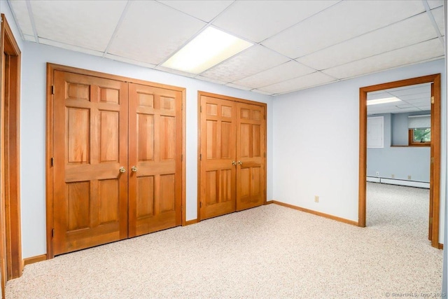 6 Big Buck Ln, Brookfield, CT 06804 - unfurnished bedroom featuring a baseboard heating unit, a drop ceiling, carpet floors, and multiple closets