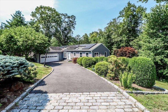 6 Big Buck Ln, Brookfield, CT 06804 - single story home with asphalt driveway, solar panels, and an attached garage