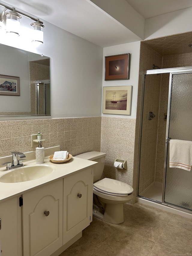 210 Jamestown Rd Unit 210, Stratford, CT 06614 - full bath with vanity, tile walls, a stall shower, tile patterned floors, and a wainscoted wall