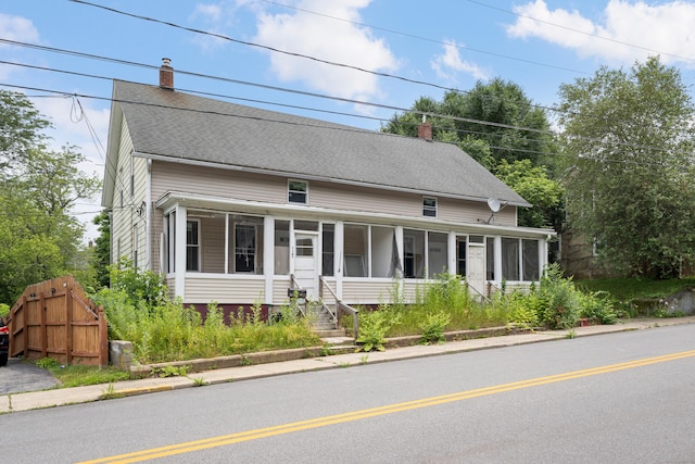 110 Franklin St, Killingly, CT 06239 - country-style home featuring a sunroom, a chimney, and roof with shingles