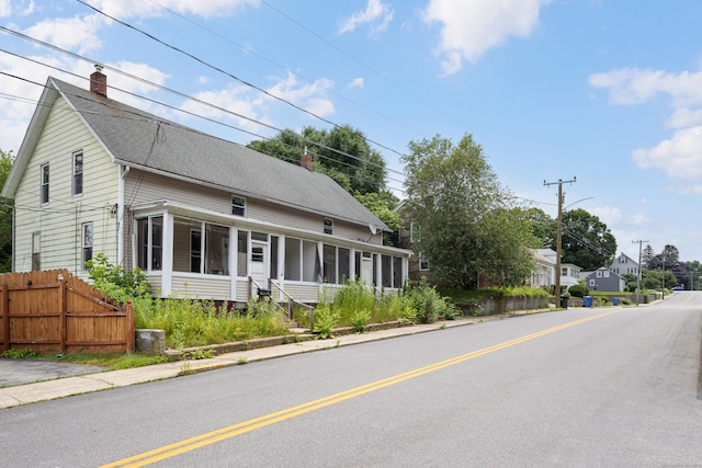 110 Franklin St, Killingly, CT 06239 - view of front facade featuring a sunroom, a chimney, and a shingled roof