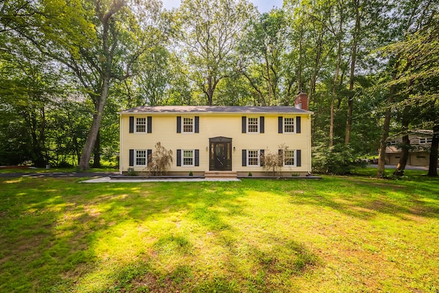 51 Brentley Dr, Shelton, CT 06484 - view of front of home featuring a chimney, a front lawn, and view of wooded area