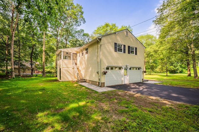 51 Brentley Dr, Shelton, CT 06484 - view of side of property with stairs, a lawn, asphalt driveway, and an attached garage