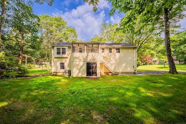 51 Brentley Dr, Shelton, CT 06484 - back of house with a sunroom, a lawn, and stairway
