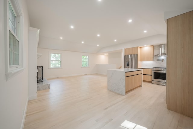 51 Brentley Dr, Shelton, CT 06484 - kitchen with stainless steel appliances, wall chimney exhaust hood, light brown cabinetry, modern cabinets, and lofted ceiling