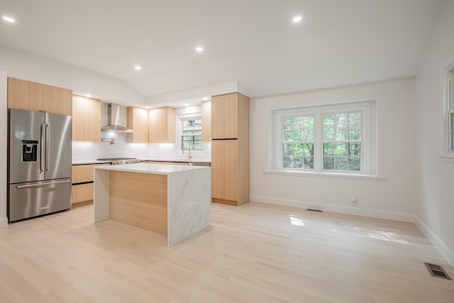 51 Brentley Dr, Shelton, CT 06484 - kitchen with appliances with stainless steel finishes, wall chimney range hood, modern cabinets, light brown cabinets, and healthy amount of natural light